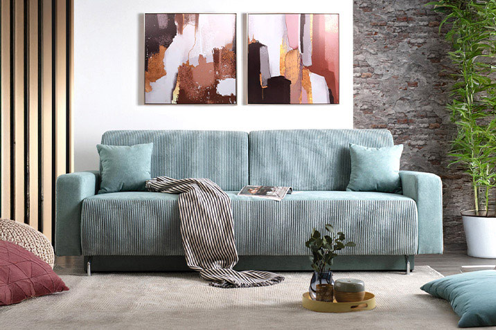 Modern sofa in petrol tones with decorative cushions for a cozy atmosphere, by CenterHome.